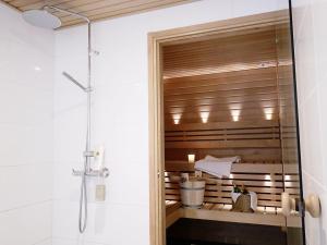 a bathroom with a shower stall and a tub at Roost Munkkisaari in Helsinki