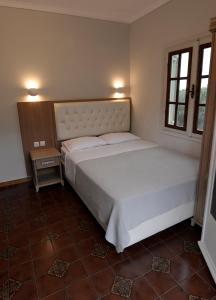 a bedroom with a large white bed in a room at Olivegrove House in Vourvourou