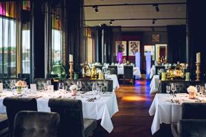a dining room with tables with white tablecloths at Der LIPPISCHE HOF in Bad Salzuflen +53 photos