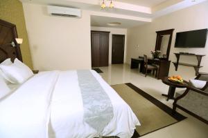 Кровать или кровати в номере Asfar Hotel Apartments