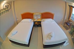 Postel nebo postele na pokoji v ubytování BCP Hotel
