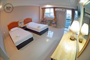 Postel nebo postele na pokoji v ubytování BCP Hotel