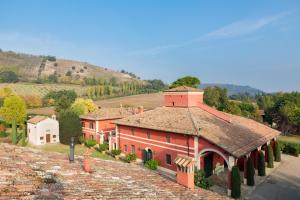 a large orange building with a tile roof at Cà Palazzo Malvasia - BolognaRooms in Sasso Marconi