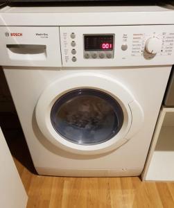 a white washing machine sitting in a kitchen at Quality Accommodation in Leeds