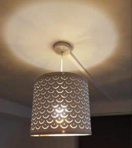 a ceiling lamp with a white pattern on it at Quality Accommodation in Leeds
