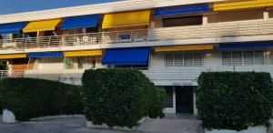 a building with a bunch of bushes in front of it at Palm beach Cannes Azur in Cannes