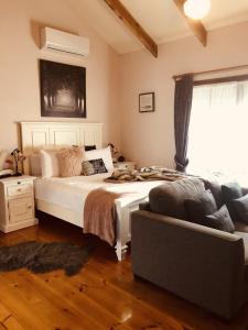 a bedroom with a large white bed and a window at Glenview Retreat Luxury Accommodation in Emerald
