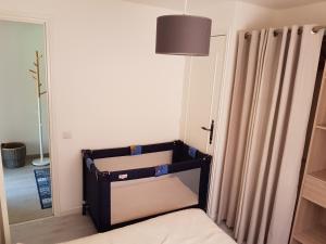 a room with a bed and a lamp and curtains at Maison Provencale in Cavalaire-sur-Mer