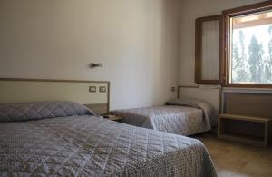 
A bed or beds in a room at Agriturismo la Ghiandaia Alghero
