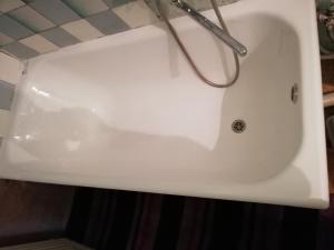 a white bath tub in a bathroom at Authentic apartment in the centre in Chişinău