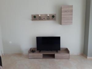 a flat screen tv sitting on a stand in a room at Villa Anastasia in Keramoti