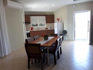 a kitchen and dining room with a table and chairs at Villa Anastasia in Keramoti