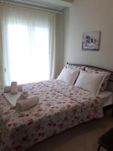 a bedroom with a bed with two towels on it at Villa Anastasia in Keramoti +35 photos