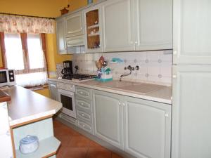 a kitchen with white cabinets and a sink at Villa Elda in Motovun