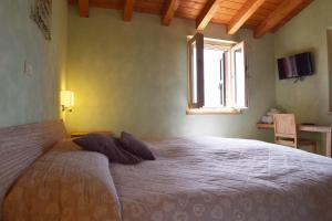 a bedroom with a large bed with a window at Colle del Giglio Resort & Spa in Ripatransone +45 photos