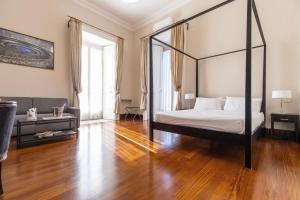 Posteľ alebo postele v izbe v ubytovaní Gramsci Suites