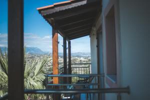 a balcony with a view of a city at Irene Komos in Pitsidia