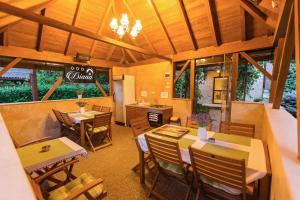 a dining room with tables and chairs in a restaurant at Pensiune Diana in Baile Felix
