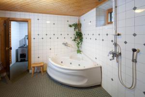 a bathroom with a large tub and a shower at Matkailutila Lahdelma in Pertunmaa +28 photos