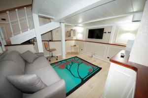a living room with a couch and a television at Daniela House 3 in Anzio