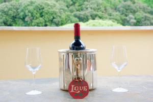 eine Flasche Wein in einer Dose mit zwei Weingläsern in der Unterkunft La Terrazza di Isabel in Rom + 25 Fotos