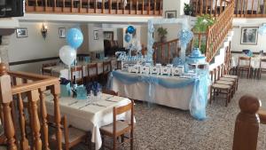 a room with tables and chairs with blue and white decorations at Albergo Ristorante Giuliana in Guarcino