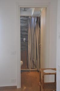 a bathroom with a shower and a toilet in a room at Apartments Scopello Inside in Scopello
