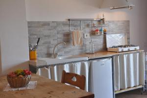 a kitchen with a sink and a counter at Apartments Scopello Inside in Scopello