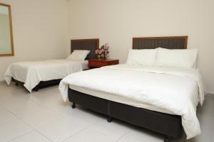 Postel nebo postele na pokoji v ubytování Hotel Rembia