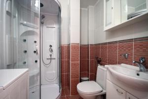a bathroom with a shower and a toilet and a sink at Guest house Villa Slavica in Sveti Stefan +105 photos