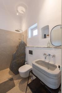 a bathroom with a sink and a toilet at Katavati - 2 Semi-detached Houses in Apollonia