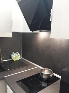 a pot on a stove top in a kitchen at Palm beach Cannes Azur in Cannes