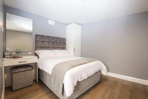 a bedroom with a large bed and a desk at The Rusty Mackerel in Teelin