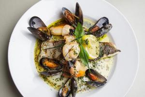 a plate of mussels and seafood on a white plate at The Rusty Mackerel in Teelin