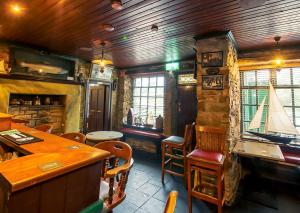 a restaurant with a bar and tables and chairs at The Rusty Mackerel in Teelin