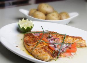 a plate of food with a piece of fish and potatoes at The Rusty Mackerel in Teelin