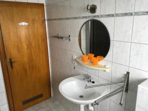 a bathroom with a sink and a mirror at Haus Nova am Bollerberg in Hallenberg