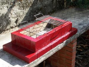 a red brick box sitting on top of a brick wall at Vila Popovski in Ljubaništa