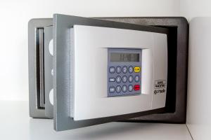 a microwave oven with a digital calculator on it at Ferienwohnung Konrad Duden in Wesel