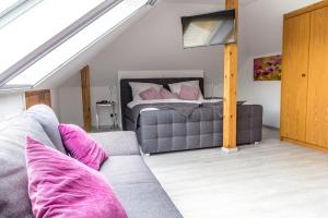 a living room with a couch and a bed at Ferienwohnung Konrad Duden in Wesel
