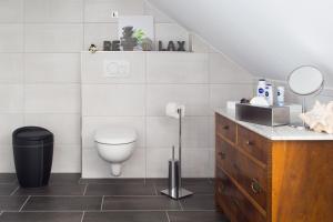 a bathroom with a toilet and a sink at Ferienwohnung Konrad Duden in Wesel +19 photos