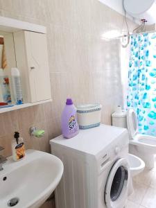 La salle de bains est pourvue d'un lave-linge et d'un lavabo. dans l'établissement shtepi plazhi, à Shëngjin