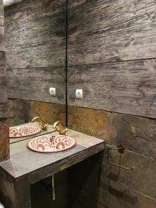 a bathroom with two sinks on a stone wall at BAVIECA-MARIMEDRANO 12 in Medinaceli