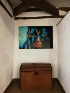 a painting of a woman on a wall in a room at BAVIECA-MARIMEDRANO 12 in Medinaceli +1 photo