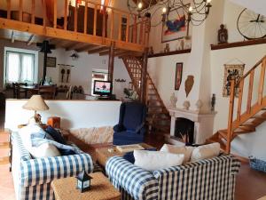 a living room with two couches and a staircase at Casa Rustica do Lagar in Lamas