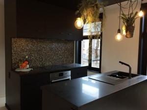 a kitchen with a sink and a counter top at Nelly in Ypres +22 photos
