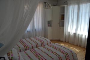 a bedroom with a bed with a blanket on it at Casa Bella in Dunavtsi