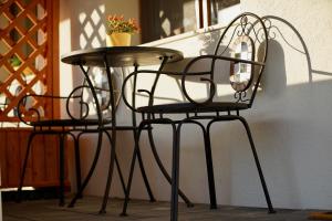 two chairs and a table on a patio at Pensiunea Rustic in Hunedoara