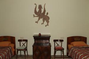 a room with two beds and two tables and two chairs at Master's House Dayan in Yerevan