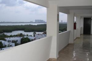 a room with a view of a river and buildings at Hotel Calypso Cancun in Cancún